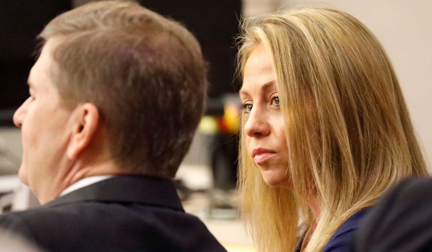 Fired Dallas police officer Amber Guyger looks toward her attorney before proceedings in her murder trial in Dallas on Sept. 25, 2019. (Tom Fox/The Dallas Morning News via AP, Pool, File)