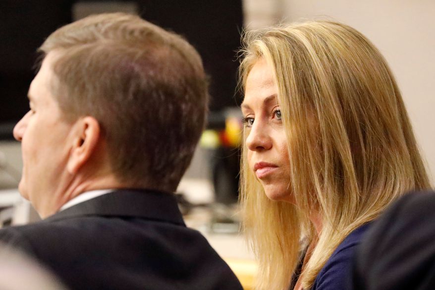 Fired Dallas police officer Amber Guyger looks toward her attorney before proceedings in her murder trial in Dallas on Sept. 25, 2019. (Tom Fox/The Dallas Morning News via AP, Pool, File)