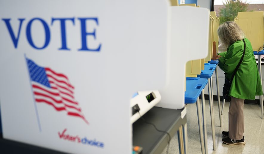 A voter cast a ballot on the first day of early voting in Minnesota at the Elections & Voter Services building, Friday, Sept. 18, 2026, in Minneapolis. (AP Photo/Ellen Schmidt)