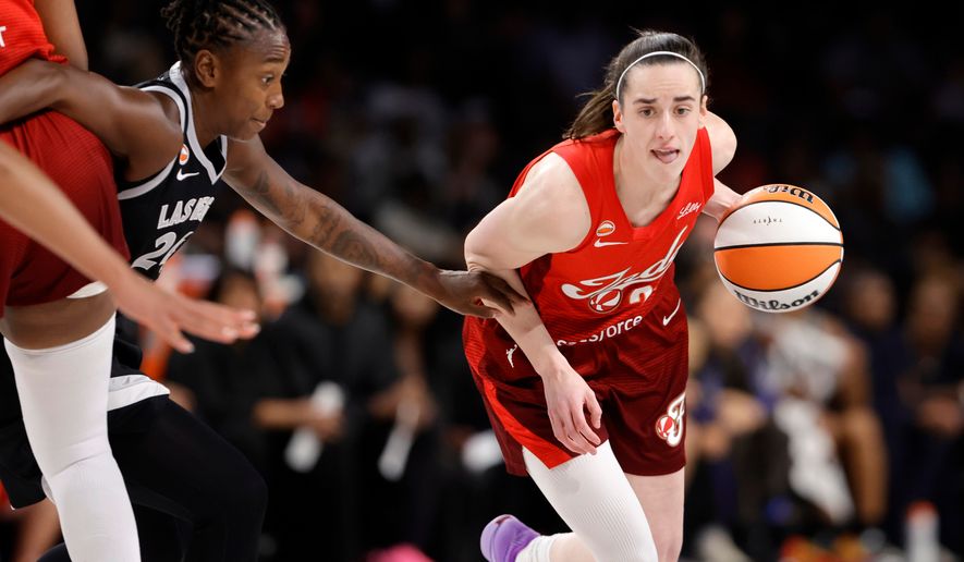 Indiana Fever guard Caitlin Clark (22) drives against Las Vegas Aces guard Jewell Loyd (24) during the first half in Game 3 of an WNBA basketball first-round playoff series Thursday, Oct.1, 2026, in Las Vegas. (AP Photo/Steve Marcus)