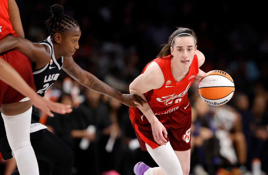 Indiana Fever guard Caitlin Clark (22) drives against Las Vegas Aces guard Jewell Loyd (24) during the first half in Game 3 of an WNBA basketball first-round playoff series Thursday, Oct.1, 2026, in Las Vegas. (AP Photo/Steve Marcus)