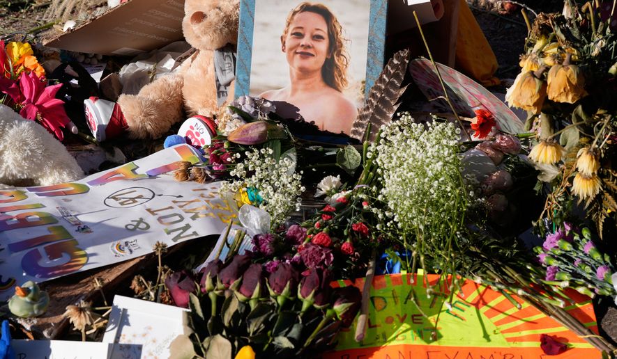 FILE - Flowers and photos are left at a memorial site for Renee Good on Saturday, Jan. 31, 2026, in Minneapolis. (AP Photo/Alex Brandon, File)