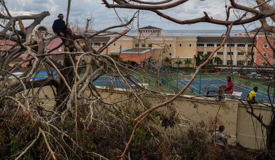 FILE - Locals gather next to a resort in Montego Bay, Jamaica, Oct. 31, 2025, in the aftermath of Hurricane Melissa. (AP Photo/Matias Delacroix, File)