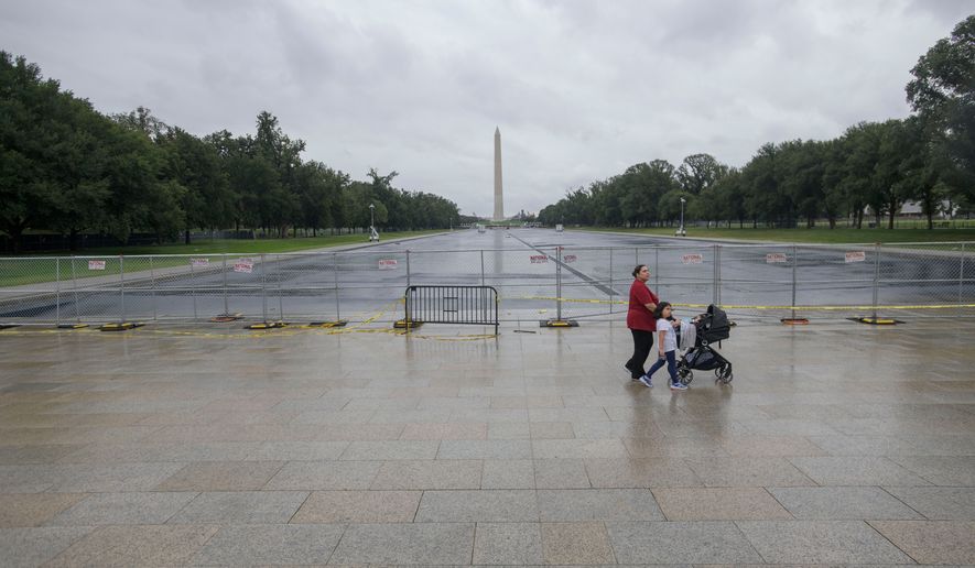 People pass by an empty Reflecting Pool at the Lincoln Memorial in Washington, Monday, Sept. 21, 2026. (AP Photo/Rod Lamkey, Jr.)