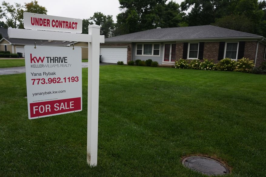 For sale sign is seen outside of a home in Arlington Heights, Ill., Wednesday, Sept. 16, 2026. (AP Photo/Nam Y. Huh)