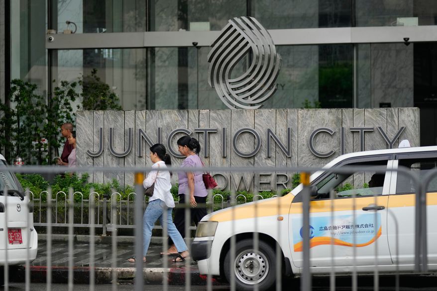 Pedestrians walk past entrance of Junction City Tower, where the American Chamber of Commerce in Myanmar has its office, on Tuesday, Sept. 15, 2026, in Yangon, Myanmar. (AP Photo, File)
