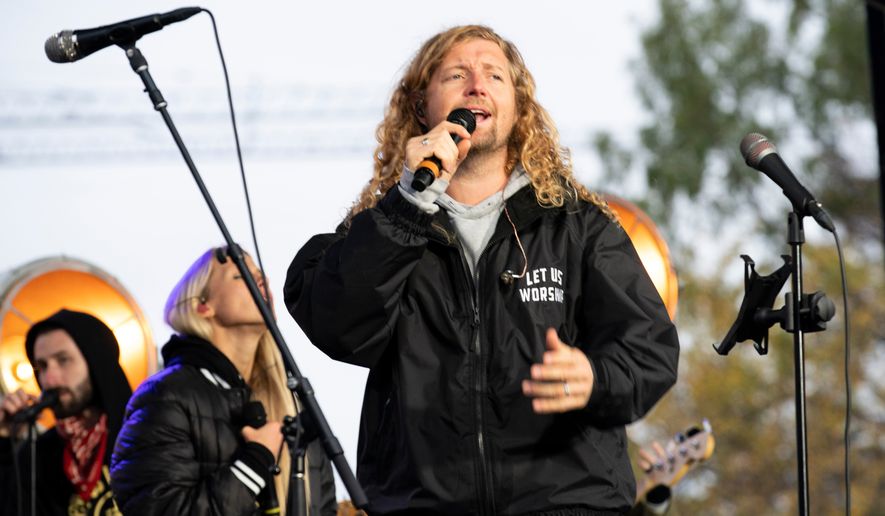 Christian musician Sean Feucht, of California, preaches to the crowd during a rally at the National Mall in Washington, Oct. 25, 2020. (AP Photo/Jose Luis Magana, File)