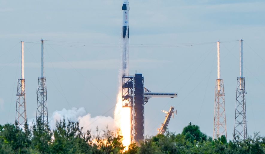 A SpaceX Falcon 9 rocket with a crew of four launches from pad 40 at the Cape Canaveral Space Force Station in Cape Canaveral, Fla., Thursday, Oct. 1, 2026. (AP Photo/John Raoux)