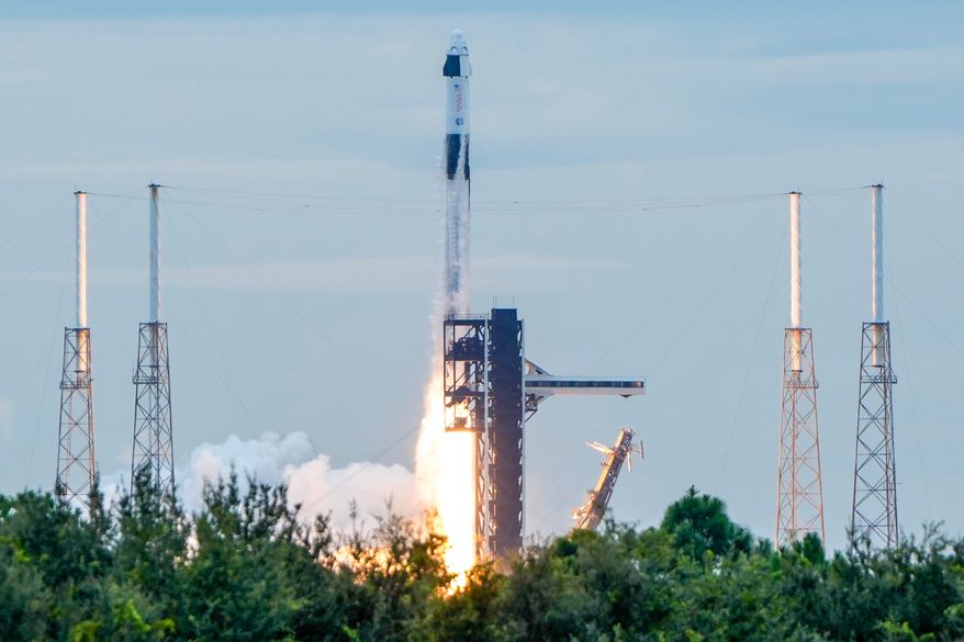 A SpaceX Falcon 9 rocket with a crew of four launches from pad 40 at the Cape Canaveral Space Force Station in Cape Canaveral, Fla., Thursday, Oct. 1, 2026. (AP Photo/John Raoux)