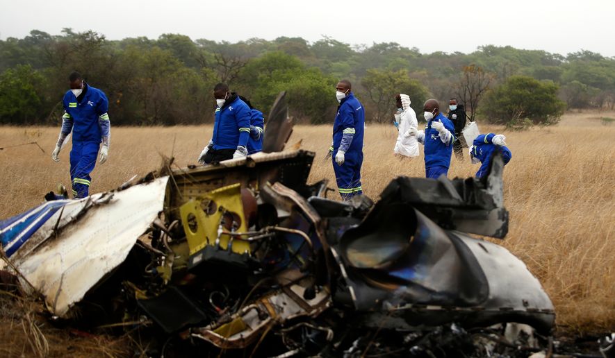 Mortuary personnel work at the scene of a helicopter crash that killed Zimbabwean businessman Wicknell Chivayo, his wife and others at Kudenga Farm near Marondera, Zimbabwe, Thursday, Oct. 1, 2026. (AP Photo)