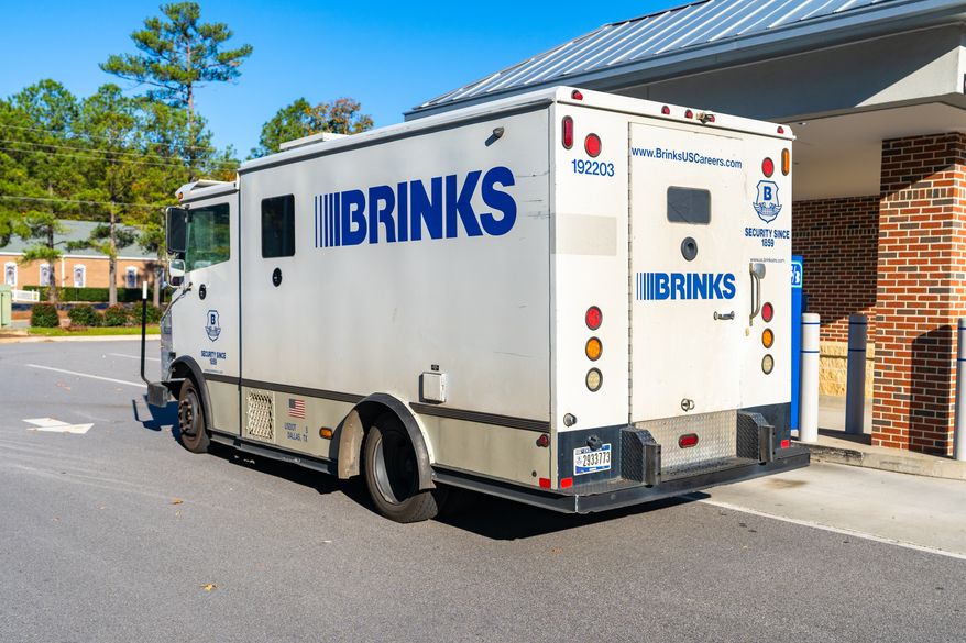 A Brink's armored security truck parked outside a bank for cash transport service. File photo credit: PJ McDonnell via Shutterstock.
