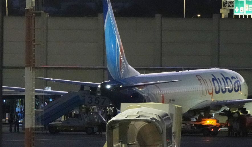 People disembark from a FlyDubai carrying Israeli passengers who had earlier been aboard another FlyDubai aircraft that made an emergency landing in Saudi Arabia approaches Ben Gurion International Airport near Tel Aviv, Israel, Wednesday, Sept. 30, 2026. (AP Photo/Ariel Schalit)