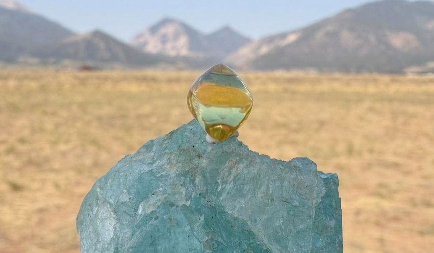 This photo provided by Jack Pearadin shows the American Dream diamond sitting on top of a large gem on Aug. 9, 2026, in Buena Vista, Colo. (Jack Pearadin via AP)