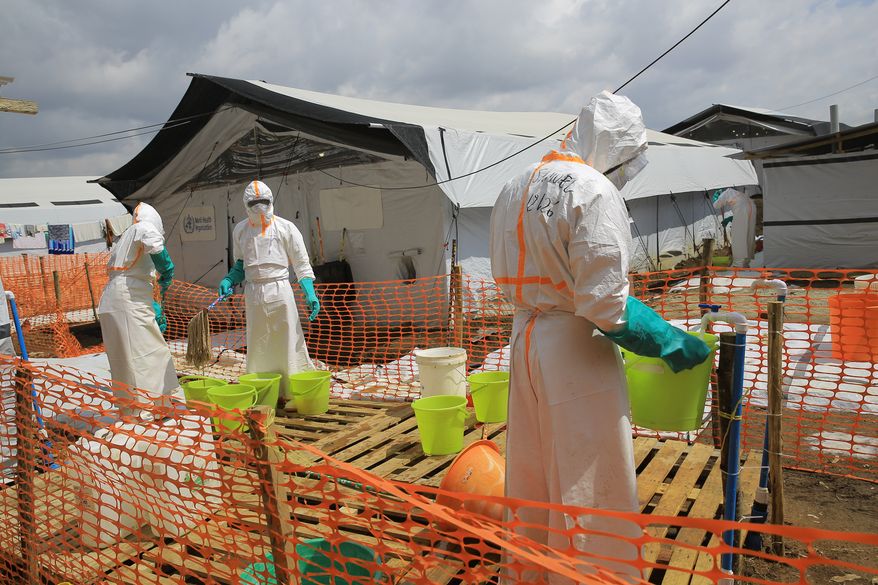Health workers clean equipment inside a Ebola treatment camp in Butembo, Congo, Wednesday, Sept. 30, 2026. (AP Photo/Sebastien Kitsa Musayi)
