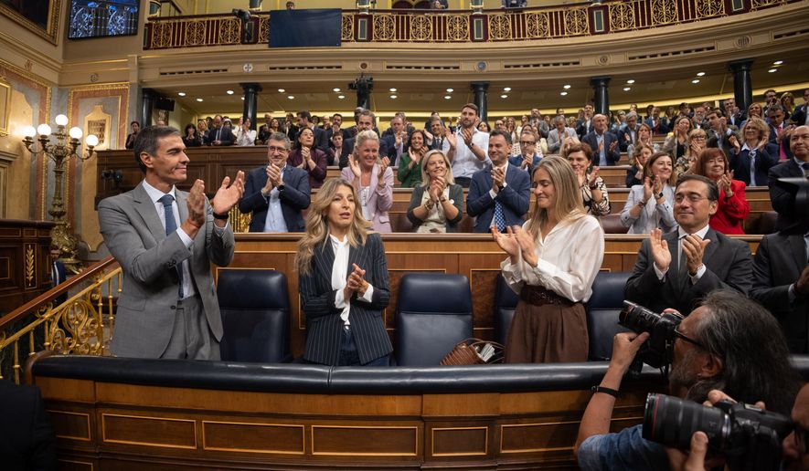 Spanish Prime Minister Pedro Sánchez, left, applauds at the Spanish parliament in Madrid, Friday Oct. 2, 2026. (Eduardo Parra/Europa Press via AP)