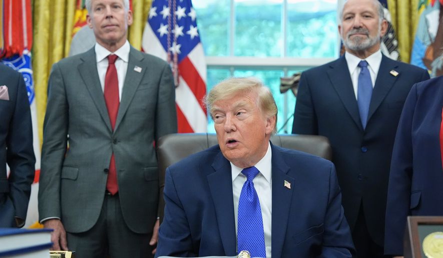 President Donald Trump speaks as Commerce Secretary Howard Lutnick, right, and Energy Secretary Chris Wright listen in the Oval Office of the White House, Monday, Sept. 28, 2026, in Washington. (AP Photo/Alex Brandon)