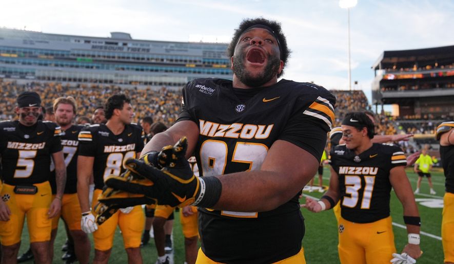 Missouri defensive tackle Jason Dowell celebrates a victory over Florida with his teammates following an NCAA college football game Saturday, Oct. 3, 2026, in Columbia, Mo. (AP Photo/Jeff Roberson)