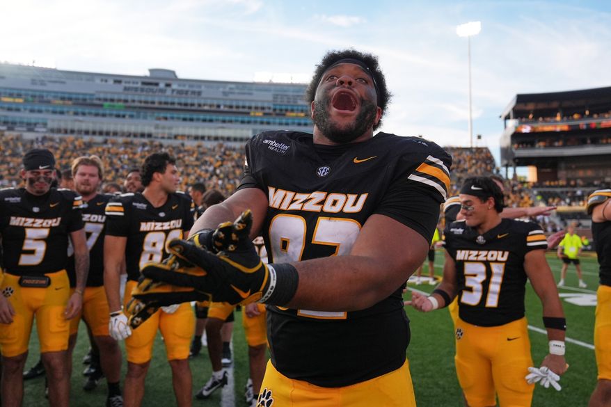 Missouri defensive tackle Jason Dowell celebrates a victory over Florida with his teammates following an NCAA college football game Saturday, Oct. 3, 2026, in Columbia, Mo. (AP Photo/Jeff Roberson)