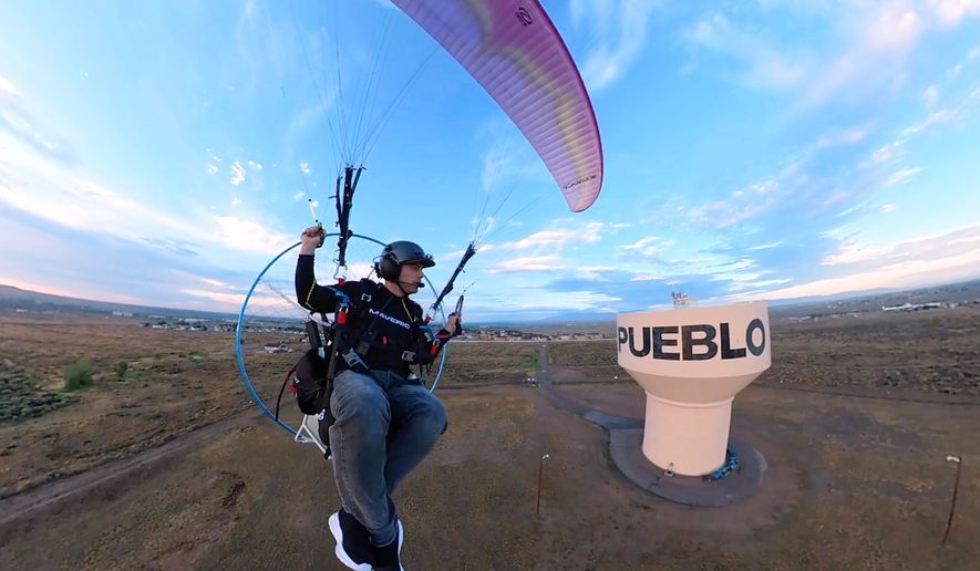 In this image taken from video provided by Jacob Hutzler shows Hutzler flies his paramotor to work as an air traffic controller in Pueblo, Colo., on Aug. 13, 2026. (Jacob Hutzler via AP)