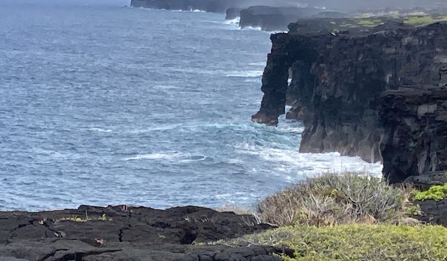 In this photo made with a smartphone, Holei Sea Arch is shown on July 12, 2021 in Hawaii Volcanoes National Park. (AP Photo/Caleb Jones)