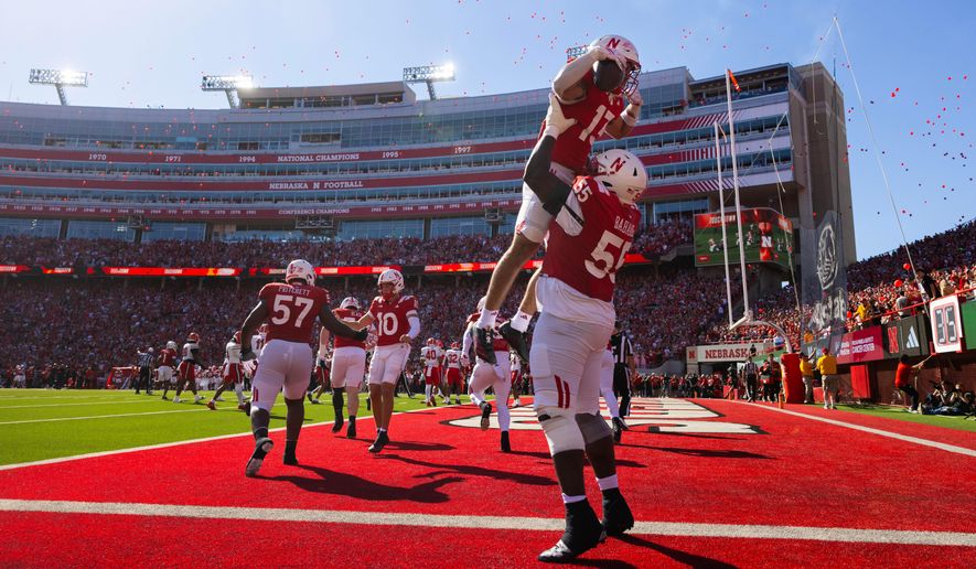 Nebraska's Tree Babalade (55) lifts Mekhi Nelson (13) in celebration of Nelson's touchdown against Maryland during the first half of an NCAA college football game Saturday, Oct. 3, 2026, in Lincoln, Neb. (AP Photo/Rebecca S. Gratz)