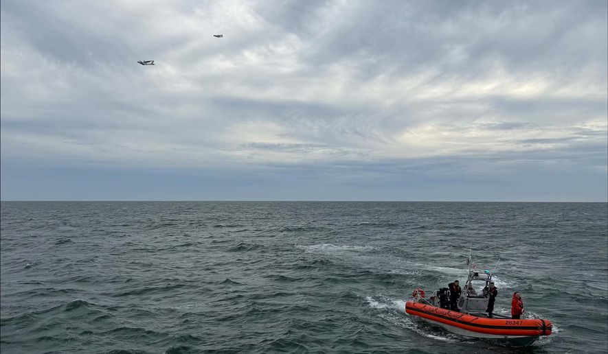 In this photo released by U.S. Coast Guard, crew members search by air and on the water for a Boston-bound air ambulance that vanished off the coast of Nantucket, Massachusetts, on Saturday, Oct. 3, 2026. (U.S. Coast Guard via AP)