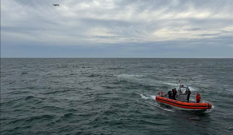 In this photo released by U.S. Coast Guard, crew members search by air and on the water for a Boston-bound air ambulance that vanished off the coast of Nantucket, Massachusetts, on Saturday, Oct. 3, 2026. (U.S. Coast Guard via AP)