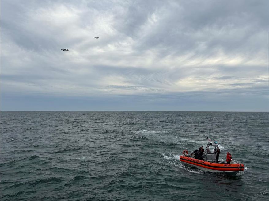 In this photo released by U.S. Coast Guard, crew members search by air and on the water for a Boston-bound air ambulance that vanished off the coast of Nantucket, Massachusetts, on Saturday, Oct. 3, 2026. (U.S. Coast Guard via AP)