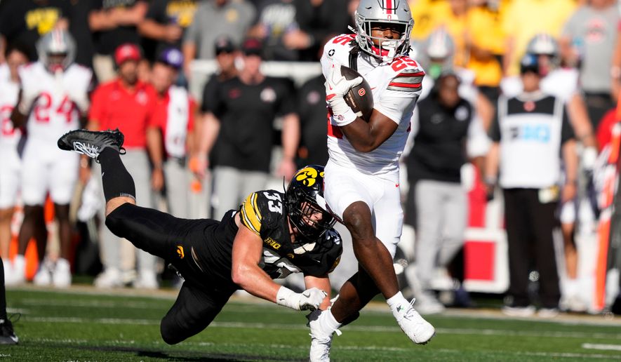 Ohio State running back Bo Jackson (25) breaks a tackle by Iowa linebacker Cam Buffington (33) during the first half of an NCAA college football game, Saturday, Oct. 3, 2026, in Iowa City, Iowa. (AP Photo/Charlie Neibergall)