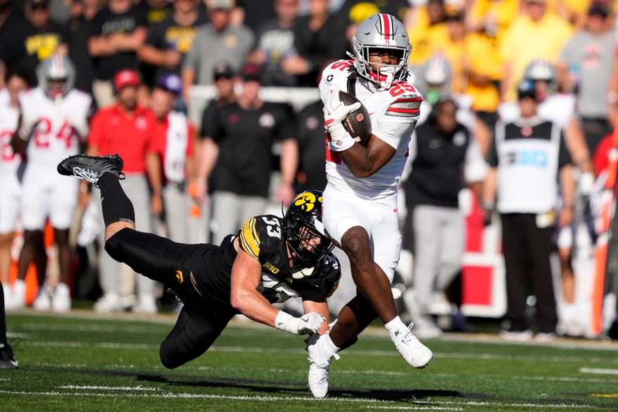 Ohio State running back Bo Jackson (25) breaks a tackle by Iowa linebacker Cam Buffington (33) during the first half of an NCAA college football game, Saturday, Oct. 3, 2026, in Iowa City, Iowa. (AP Photo/Charlie Neibergall)
