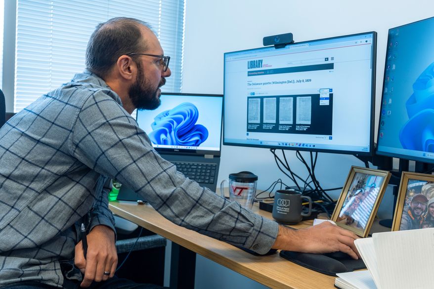 Smithsonian's Data Scientist Mike Trizna, looks on a computer monitor at a July 8, 1809 ,edition of the The Delaware Gazette from Wilmington, Del., as he works Sept. 29, 2026, in Washington. (AP Photo/Manuel Balce Ceneta)