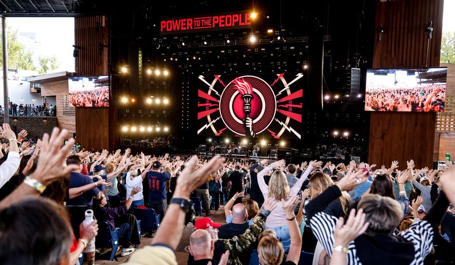 Festivalgoers wave their arms during a performance at the Power To The People Festival on Saturday, Oct. 3, 2026, in Columbia, Md. (AP Photo/Alyssa Piazza)
