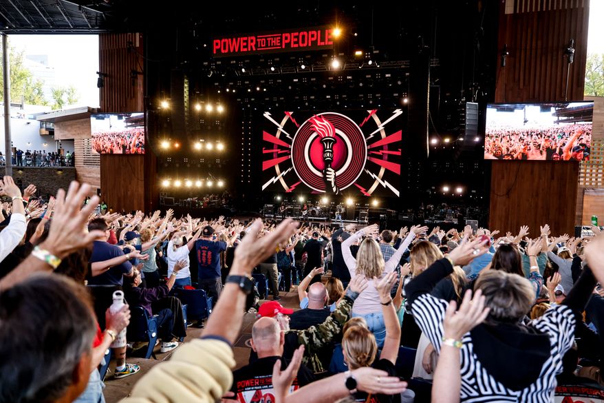 Festivalgoers wave their arms during a performance at the Power To The People Festival on Saturday, Oct. 3, 2026, in Columbia, Md. (AP Photo/Alyssa Piazza)