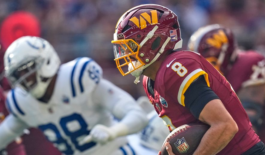 Washington Commanders quarterback Marcus Mariota (8) runs with the ball during an NFL football game against Indianapolis Colts in London, Sunday, Oct. 4, 2026. (AP Photo/David J. Phillip)