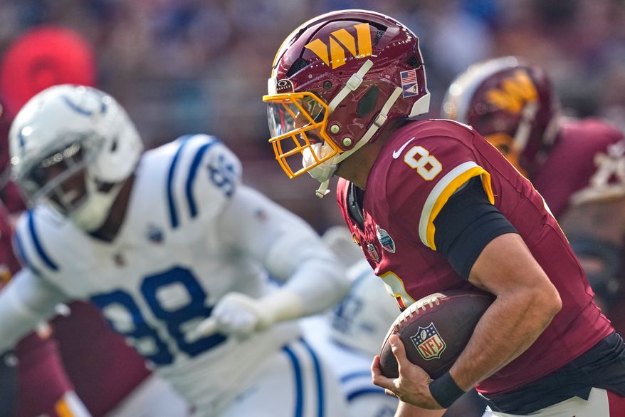 Washington Commanders quarterback Marcus Mariota (8) runs with the ball during an NFL football game against Indianapolis Colts in London, Sunday, Oct. 4, 2026. (AP Photo/David J. Phillip)