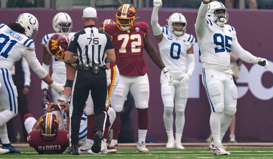 Indianapolis Colts defensive tackle Adetomiwa Adebawore (95) reacts after Washington Commanders quarterback Marcus Mariota (8), left, was sacked during an NFL football game in London, Sunday, Oct. 4, 2026. (AP Photo/David J. Phillip)