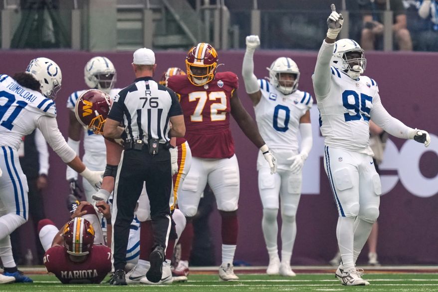 Indianapolis Colts defensive tackle Adetomiwa Adebawore (95) reacts after Washington Commanders quarterback Marcus Mariota (8), left, was sacked during an NFL football game in London, Sunday, Oct. 4, 2026. (AP Photo/David J. Phillip)