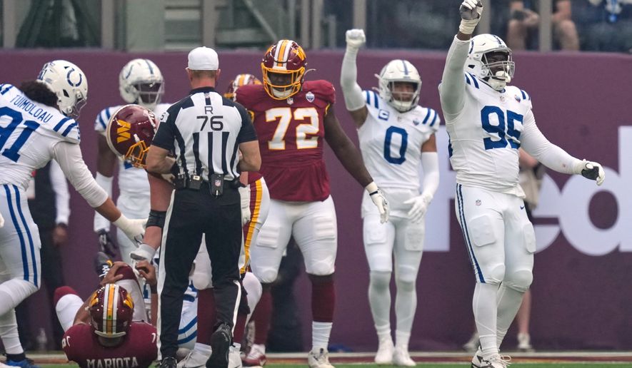 Indianapolis Colts defensive tackle Adetomiwa Adebawore (95) reacts after Washington Commanders quarterback Marcus Mariota (8), left, was sacked during an NFL football game in London, Sunday, Oct. 4, 2026. (AP Photo/David J. Phillip)