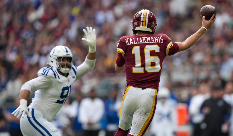 Indianapolis Colts defensive end Jaylahn Tuimoloau (91) puts pressure on a pass by Washington Commanders quarterback Athan Kaliakmanis (16) during an NFL football game in London, Sunday, Oct. 4, 2026. (AP Photo/David J. Phillip)
