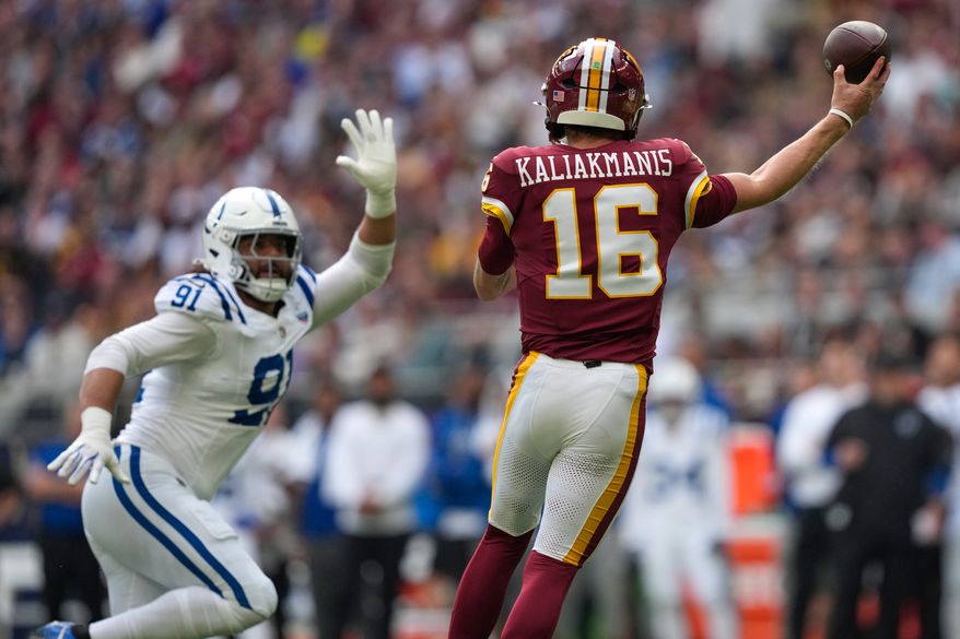 Indianapolis Colts defensive end Jaylahn Tuimoloau (91) puts pressure on a pass by Washington Commanders quarterback Athan Kaliakmanis (16) during an NFL football game in London, Sunday, Oct. 4, 2026. (AP Photo/David J. Phillip)