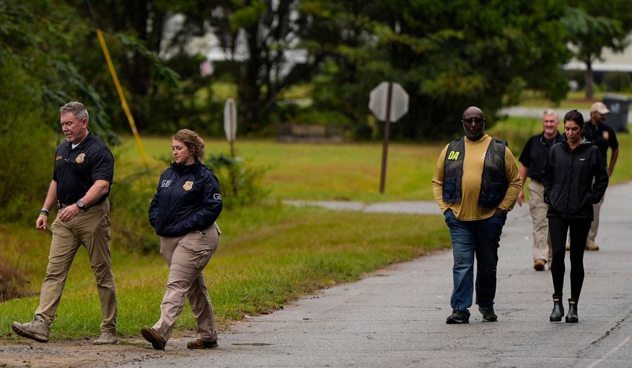 Authorities investigate the scene of a mass shooting where at least two people died and 35 were injured when struck by bullets Sunday morning, according to the Georgia Bureau of Investigation, Sunday, Oct. 4, 2026, in Vienna, Ga. (AP Photo/Mike Stewart)