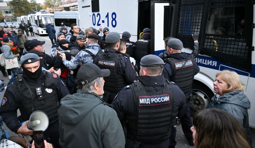 In this photo released by Russian Communist Party Press Service, Police detain demonstrators after a rally marking the 33rd anniversary of the events in memory of those who were killed during the 1993 bloody clashes between government forces and supporters of the rebellious parliament, in Moscow, on Sunday, Oct. 4, 2026. (Russian Communist Party Press Service via AP)