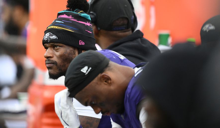 Baltimore Ravens quarterback Lamar Jackson, left, looks out from the bench during the second half of an NFL football game against the Tennessee Titans in Baltimore, Sunday, Oct. 4, 2026. (AP Photo/Nick Wass)