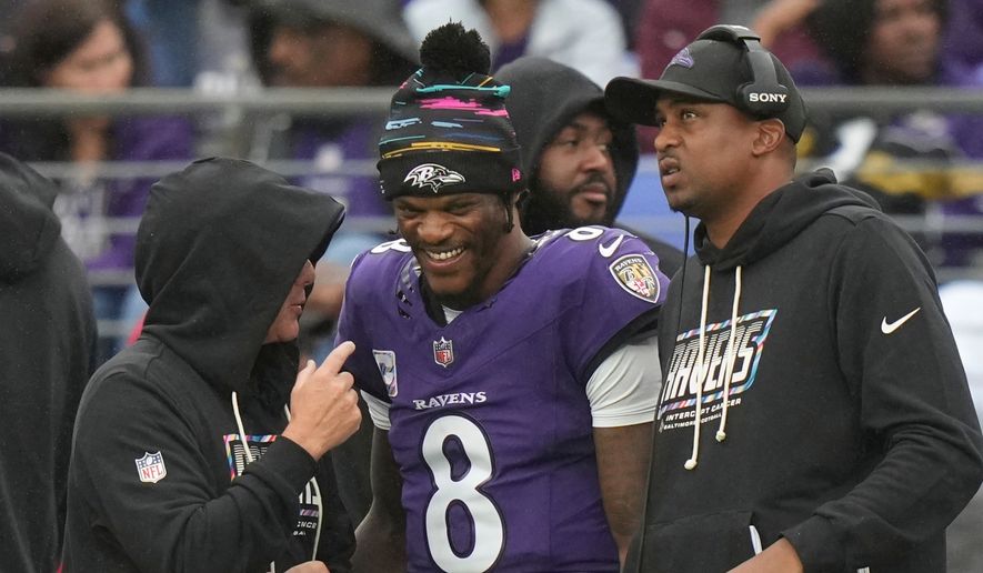 Baltimore Ravens quarterback Lamar Jackson (8) talks to team personnel on the sideline during the second half of an NFL football game against the Tennessee Titans in Baltimore, Sunday, Oct. 4, 2026. (AP Photo/Stephanie Scarbrough)