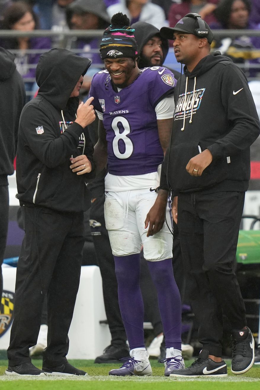 Baltimore Ravens quarterback Lamar Jackson (8) talks to team personnel on the sideline during the second half of an NFL football game against the Tennessee Titans in Baltimore, Sunday, Oct. 4, 2026. (AP Photo/Stephanie Scarbrough)