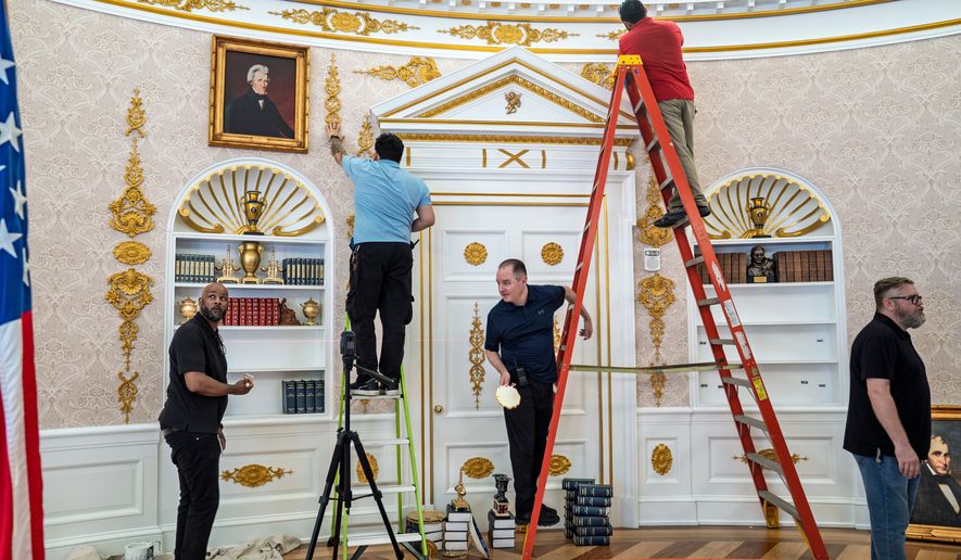 A replica of President Donald Trump's Oval Office is updated to the current decor by workers at "The People's House: A White House Experience," in Washington, Friday, Oct. 2, 2026. (AP Photo/J. Scott Applewhite)