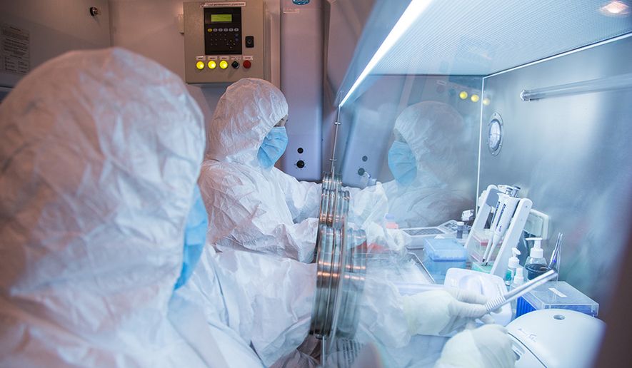 This undated photo released in 2019 by the Irkutsk Anti-Plague Research Institute of Siberia and Far East, shows the institute workers in a lab. (The Irkutsk Anti-Plague Research Institute of Siberia and Far East via AP)