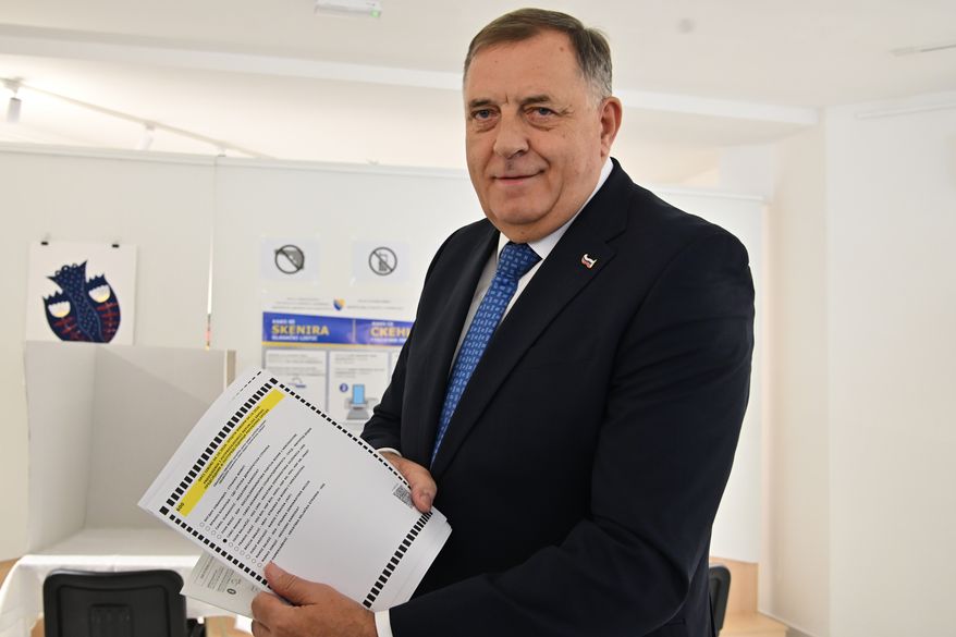 Milorad Dodik, former president of the Serb-majority Republika Srpska shows a ballot paper at a polling station in Laktasi, northwest of Sarajevo, Bosnia, Sunday, Oct. 4, 2026. (AP Photo/Radivoje Pavicic)