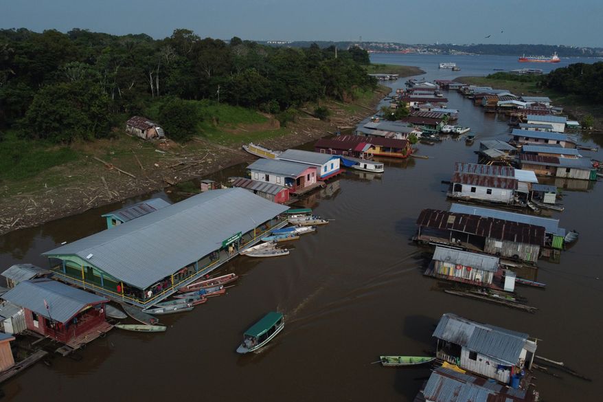 Boats are moored to a school serving as a polling station during general elections in Iranduba, Brazil, Sunday, Oct. 4, 2026. (AP Photo/Edmar Barros)