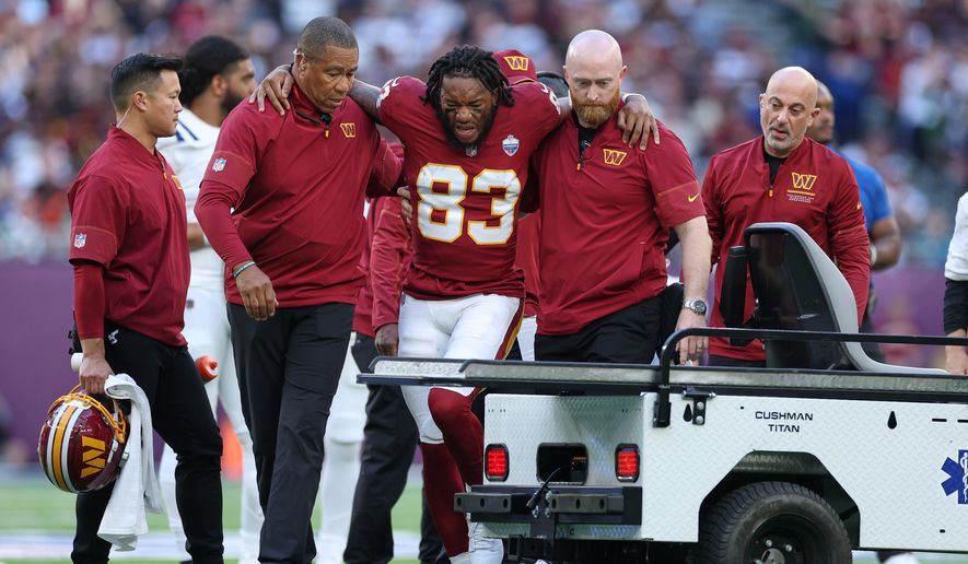 Washington Commanders wide receiver Jaylin Lane (83) is taken from the field injured during an NFL football game against Indianapolis Colts in London, Sunday, Oct. 4, 2026. (AP Photo/Ian Walton)